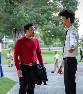 image of two men standing and conversing