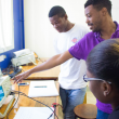 Lab technician working with students