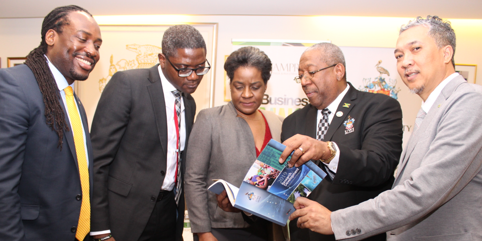 Principal viewing Research for Development publication with other stakeholders