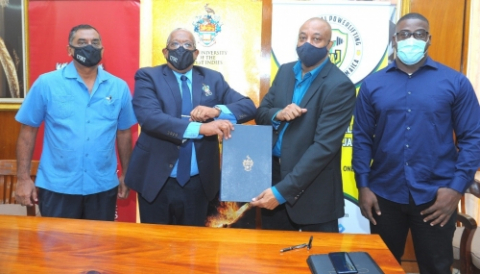 Dr Akshai Mansingh, Professor Dale Webber, Mr Michael Blair and Mr. Richard Radcliffe at signing ceremony