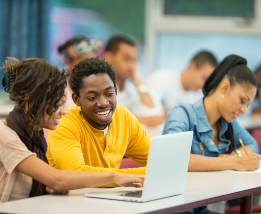 Students looking at computer and working together