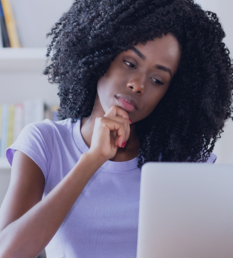 Female student at computer in deep thought