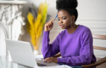 Black female student thinking while working at computer