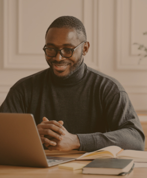 Student looking at laptop and smiling