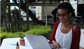 FSS Student using laptop at booth