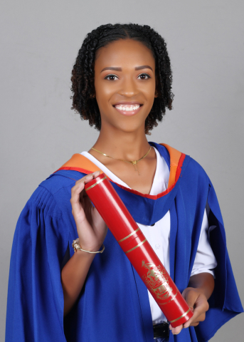 Tamarnie hold UWI scroll in graduation gown