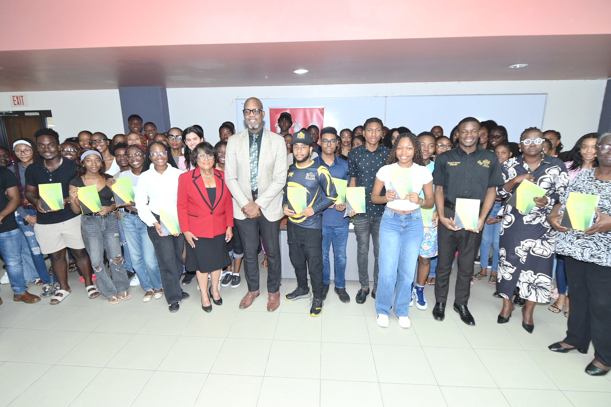 Pictured: First year law students pose with their printed copies of the Constitution and Minister of State, Hon. Marisa Dalrymple-Philibert (center left).